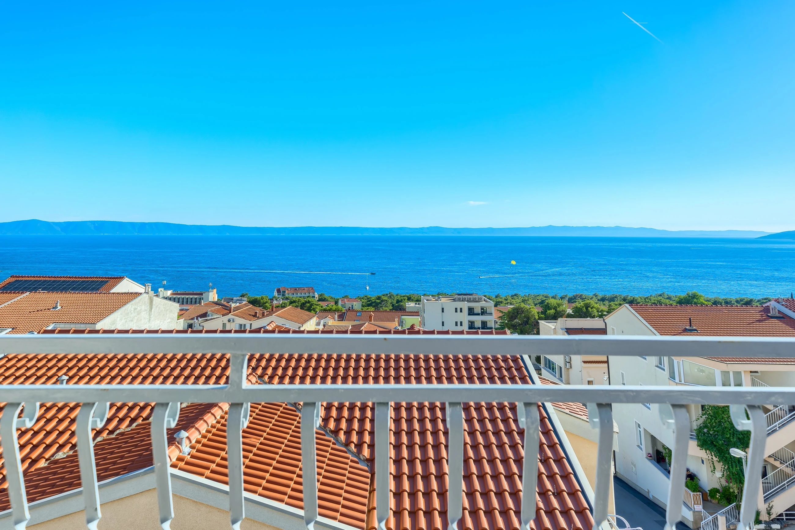 Adriatic Sea and terracotta rooftops viewed from a private balcony in Makarska
